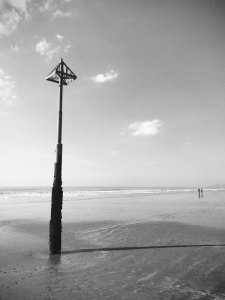 Two distant figures on Borth beach, Wales.